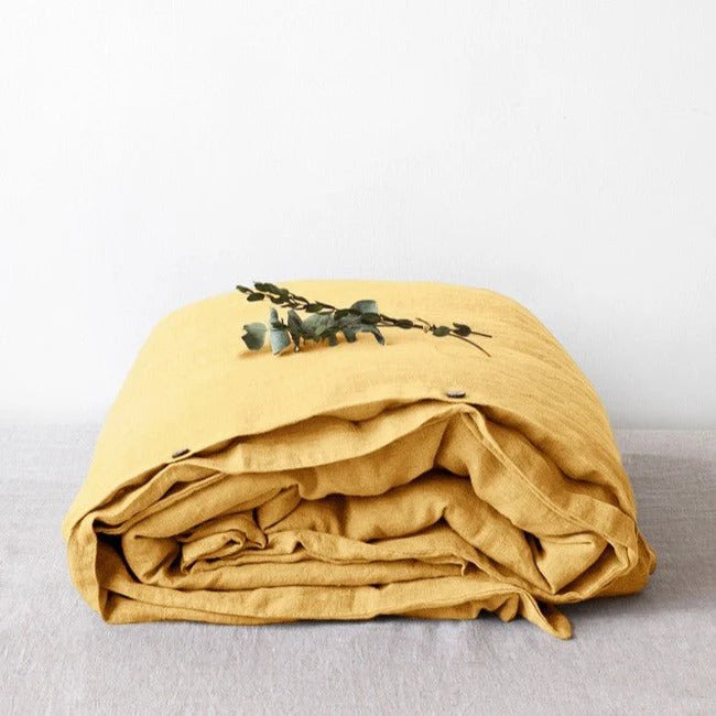 Butter yellow linen duvet cover on a bed