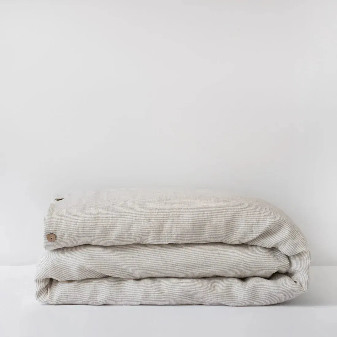 Natural stripes linen duvet cover on a bed