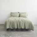 Sage green linen duvet cover set on a bed