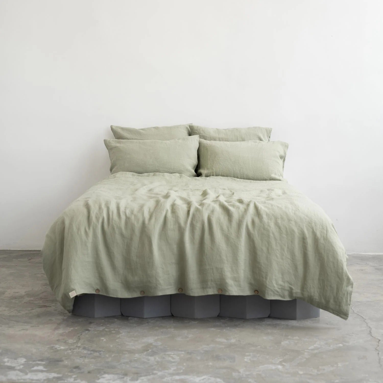 Sage green linen duvet cover set on a bed