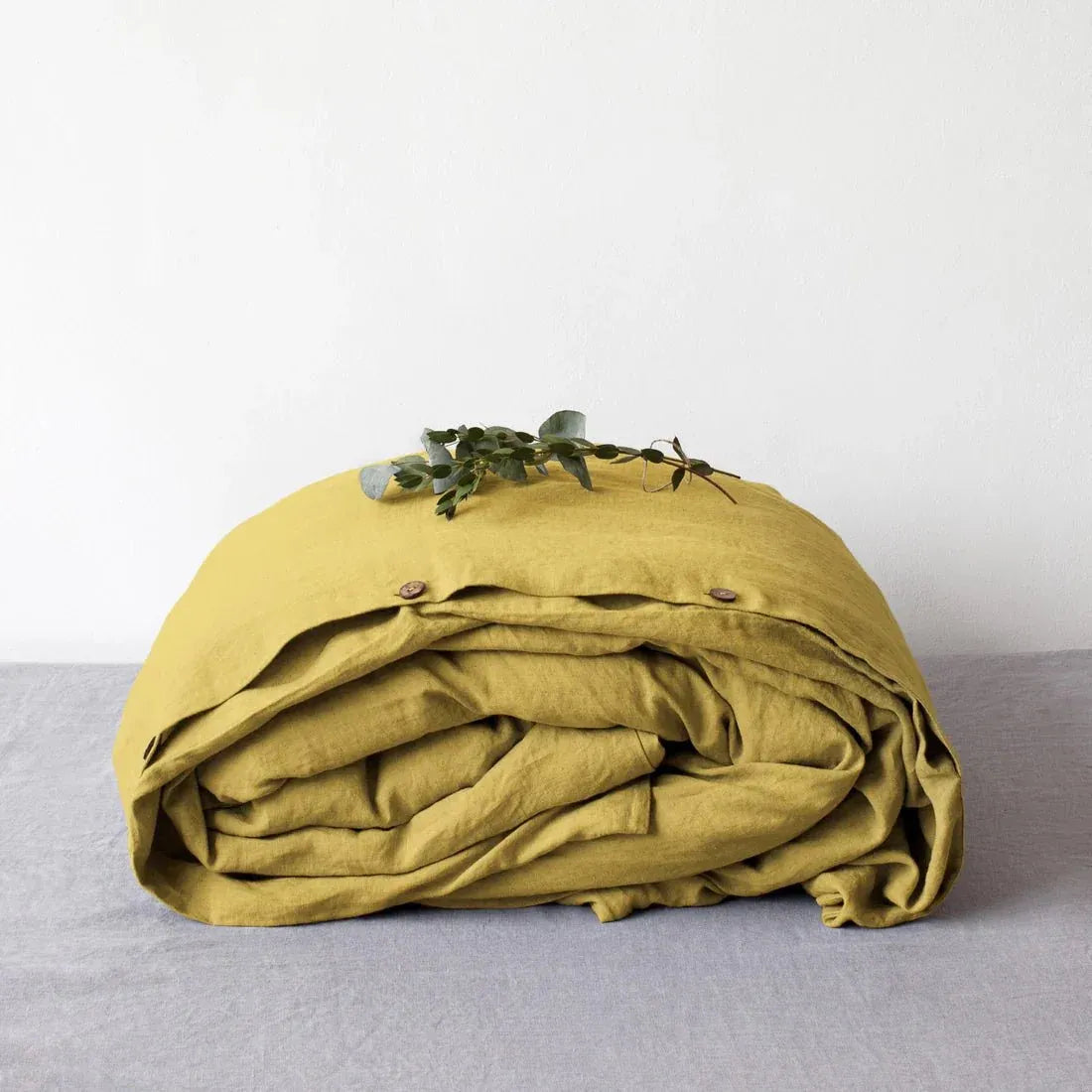 Lemon curry yellow linen duvet cover on a bed